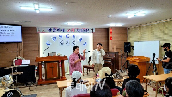 서문로교회 이운희 목사(사진 왼쪽)가 김기경 피아니스트를 소개하고 있다.