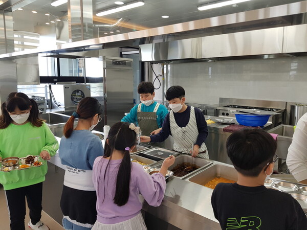 식당 봉사를 자처한 글로벌하담기독학교 5학년 학생들이 학우들에게 점심 식사를 배식하고 있다. @출처=글로벌하담기독학교