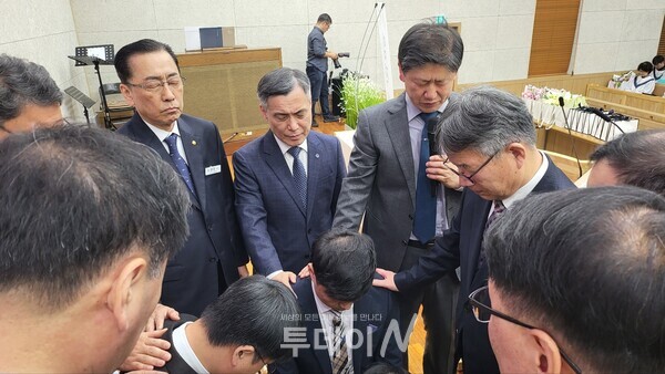 안수위원 세분 집사 장립을 위하여 안수 하고 있다.